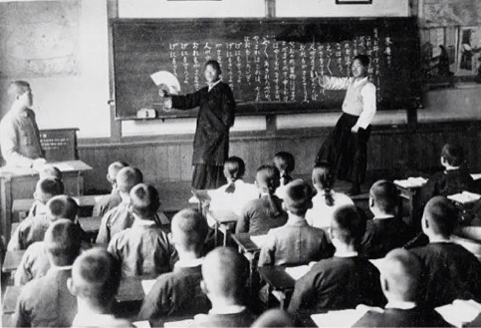 An old snapshot of Korean children immersed in Japanese language lessons, under the watchful eye of their teachers in traditional attire.