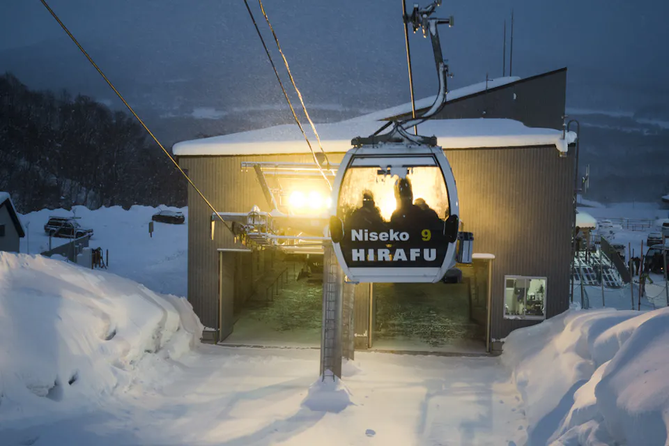 Skiers and Snowboarders Ride the Gondola at Grand Hirafu Ski Resort in Niseko