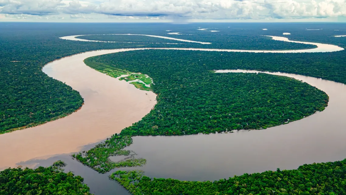 Aerial view of the Amazon River winding through dense forests in Amazonas
