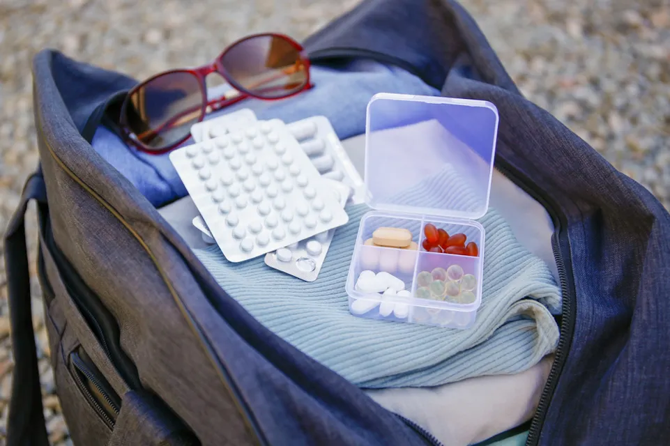 Clothes and pills in a travel bag