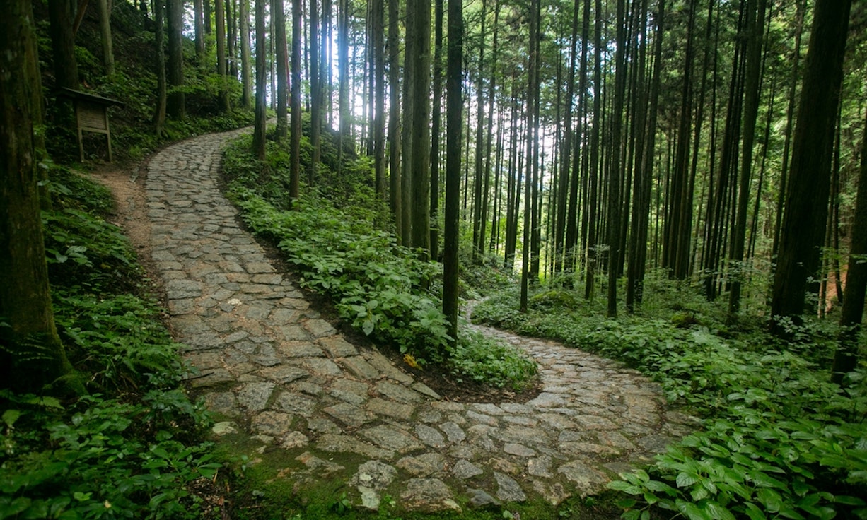 Walking the cobblestone road following the Nakasendo trail between Tsumago and Magome in Kiso Valley, Japan Walking the cobblestone road following the Nakasendo trail between Tsumago and Magome in Kiso Valley, Japan