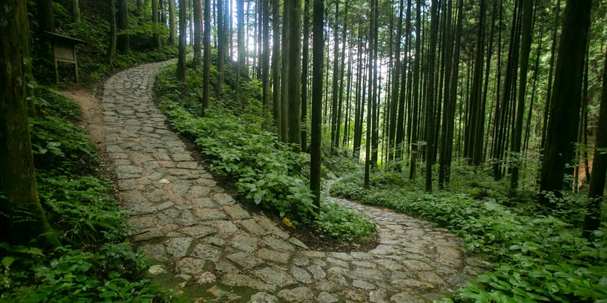 Walking the cobblestone road following the Nakasendo trail between Tsumago and Magome in Kiso Valley, Japan Walking the cobblestone road following the Nakasendo trail between Tsumago and Magome in Kiso Valley, Japan
