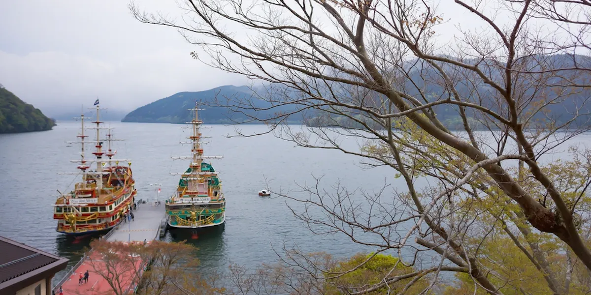 View of Hakone sightseeing cruise pirate ships docks on pier of Togendai Station at Lake Ashi View of Hakone sightseeing cruise pirate ships docks on pier of Togendai Station at Lake Ashi