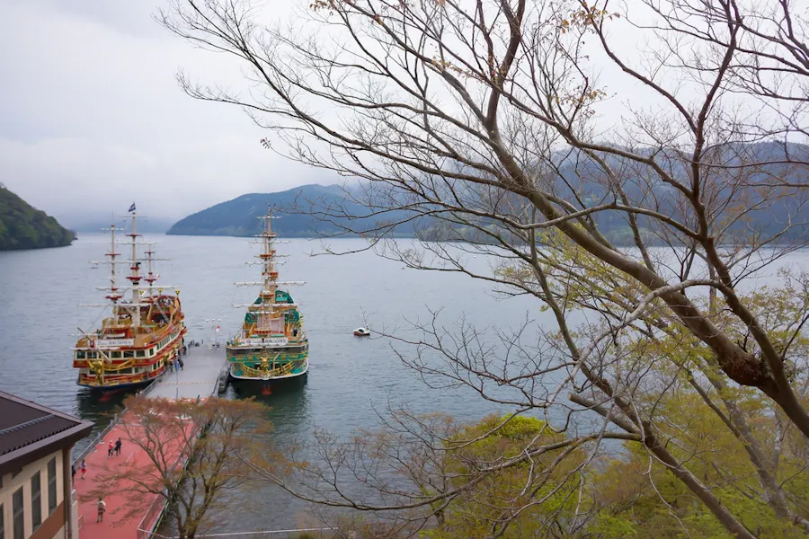 View of Hakone sightseeing cruise pirate ships docks on pier of Togendai Station at Lake Ashi