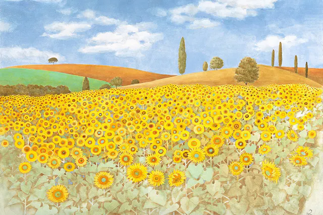 A vibrant field of sunflowers stretches across rolling hills under a blue sky with white clouds. Green and brown hills, scattered trees, and tall cypress trees appear in the background.
