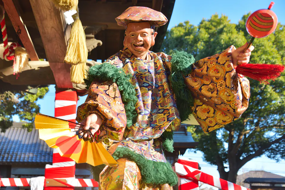 Setsubun-sai (Setsubun) Festival A masked performer in bright robes holding a rattle at a Setsubun ceremony