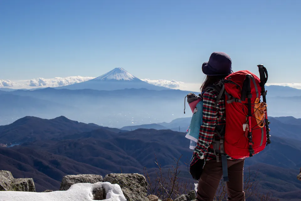 Rear view of a female climber looking at Mt. Fuji