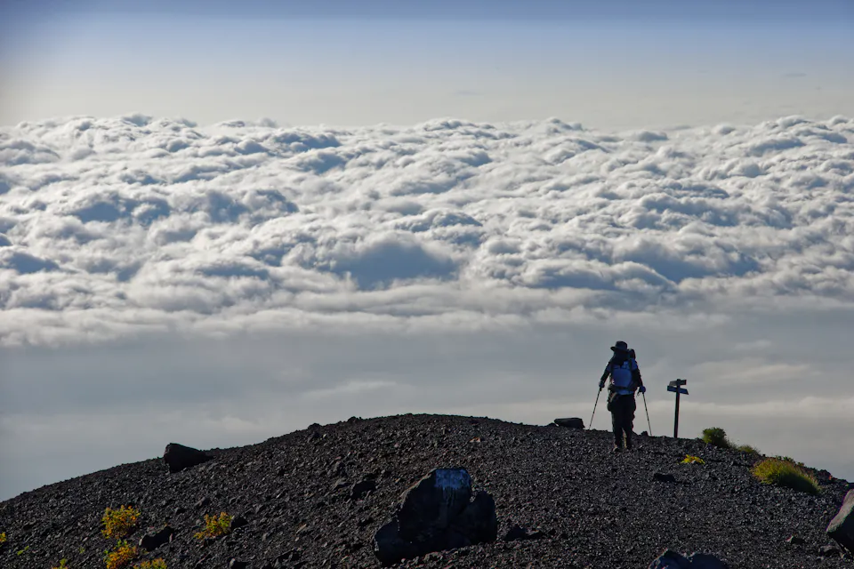 Climbers and sea of clouds near Mt. Fuji and Hoei crater