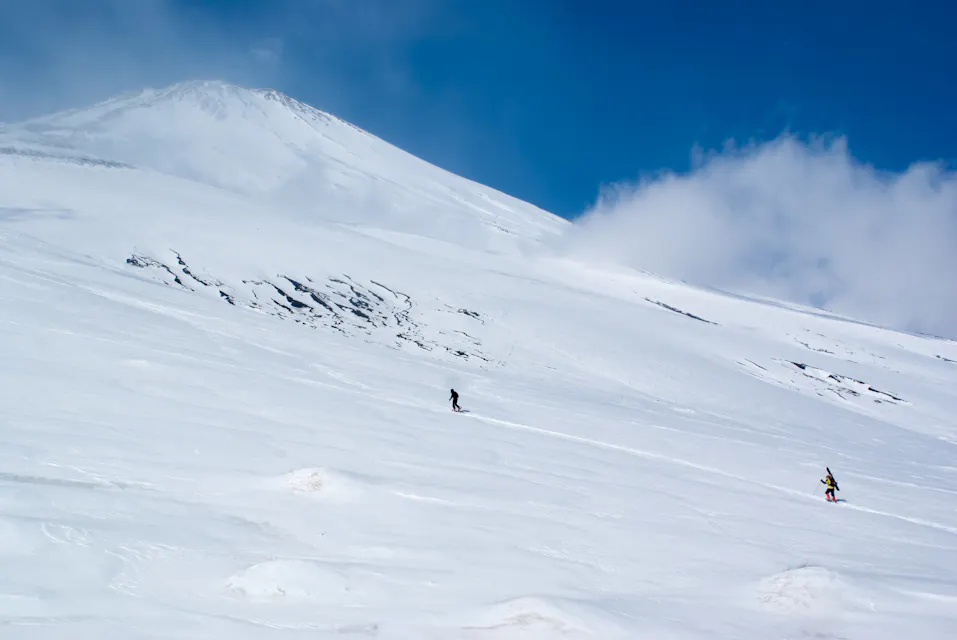 Mountain skiers climbing Mt. Fuji in winter