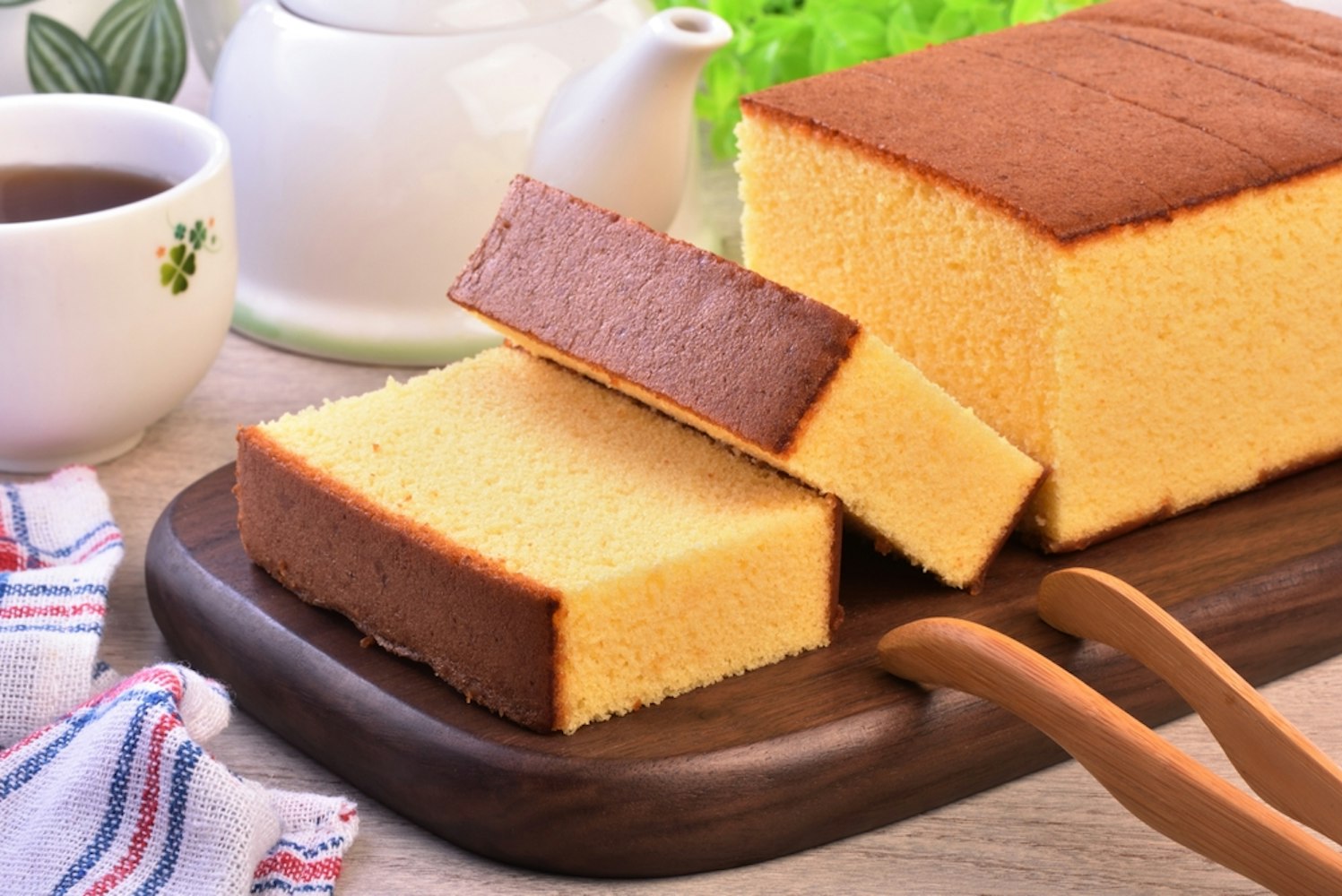 Castella (kasutera) - Delicious sliced sponge cake on wooden plate
