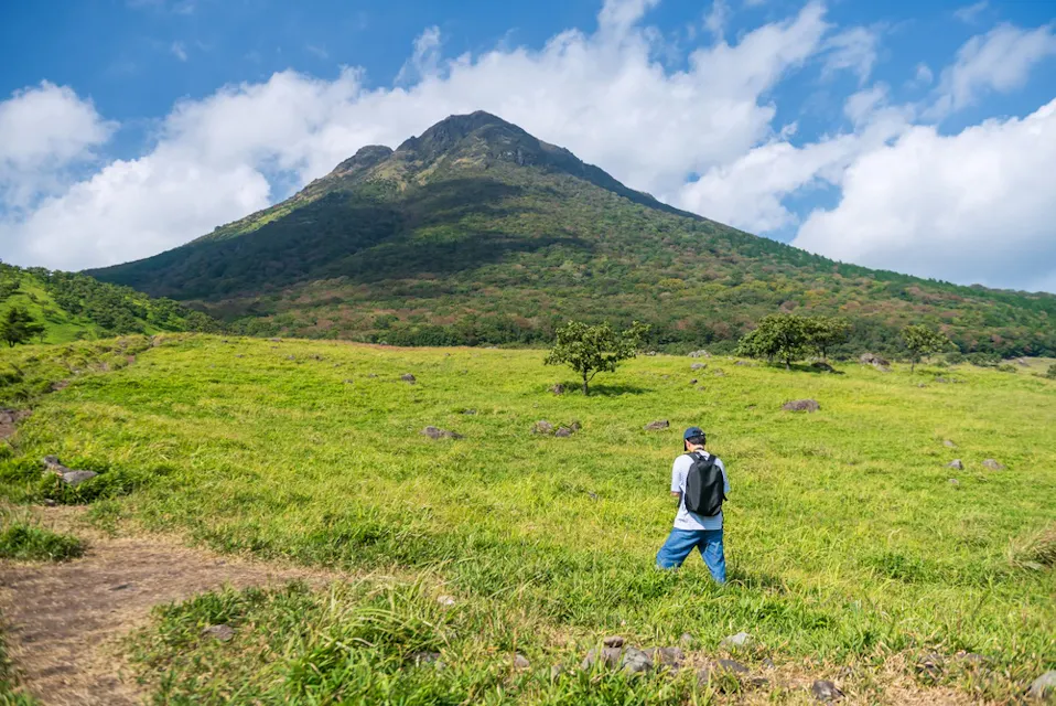 Japanese man at Yufu Tozanguchi hiking trail of mount Yufu