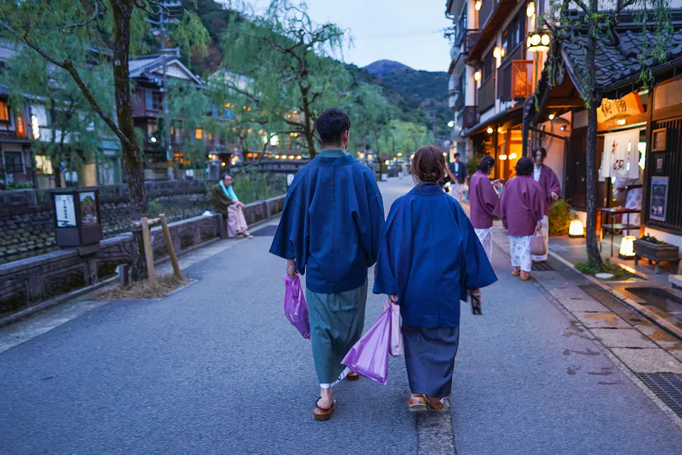 Japanese couple wearing yukata is seen walking at Kinosaki Onsen Japanese couple wearing yukata is seen walking at Kinosaki Onsen