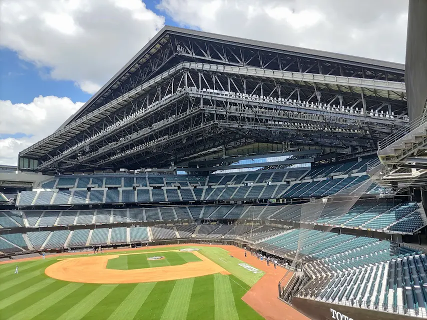 Es Con Field's movable roof spans 166 meters and opens or closes in about 25 minutes The retractable roof of Es Con Field Hokkaido open to a partly cloudy sky above the empty seating bowl