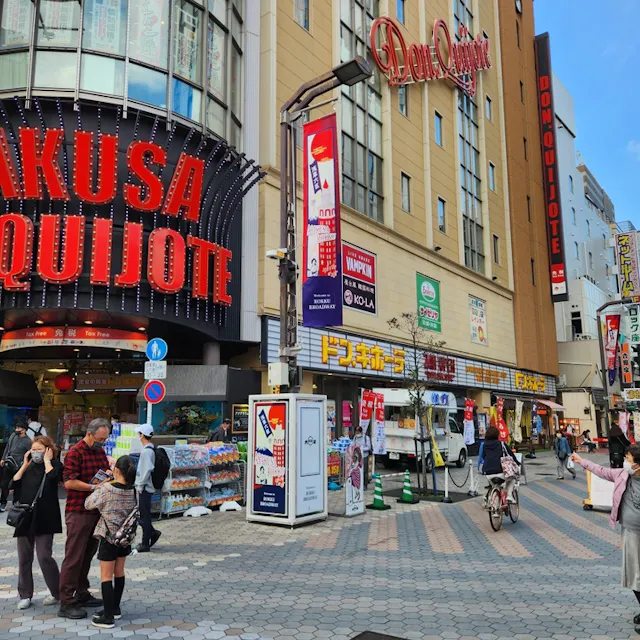 A bustling street scene in Tokyo's Asakusa District in the bright light of day A bustling street scene in Tokyo's Asakusa District in the bright light of day