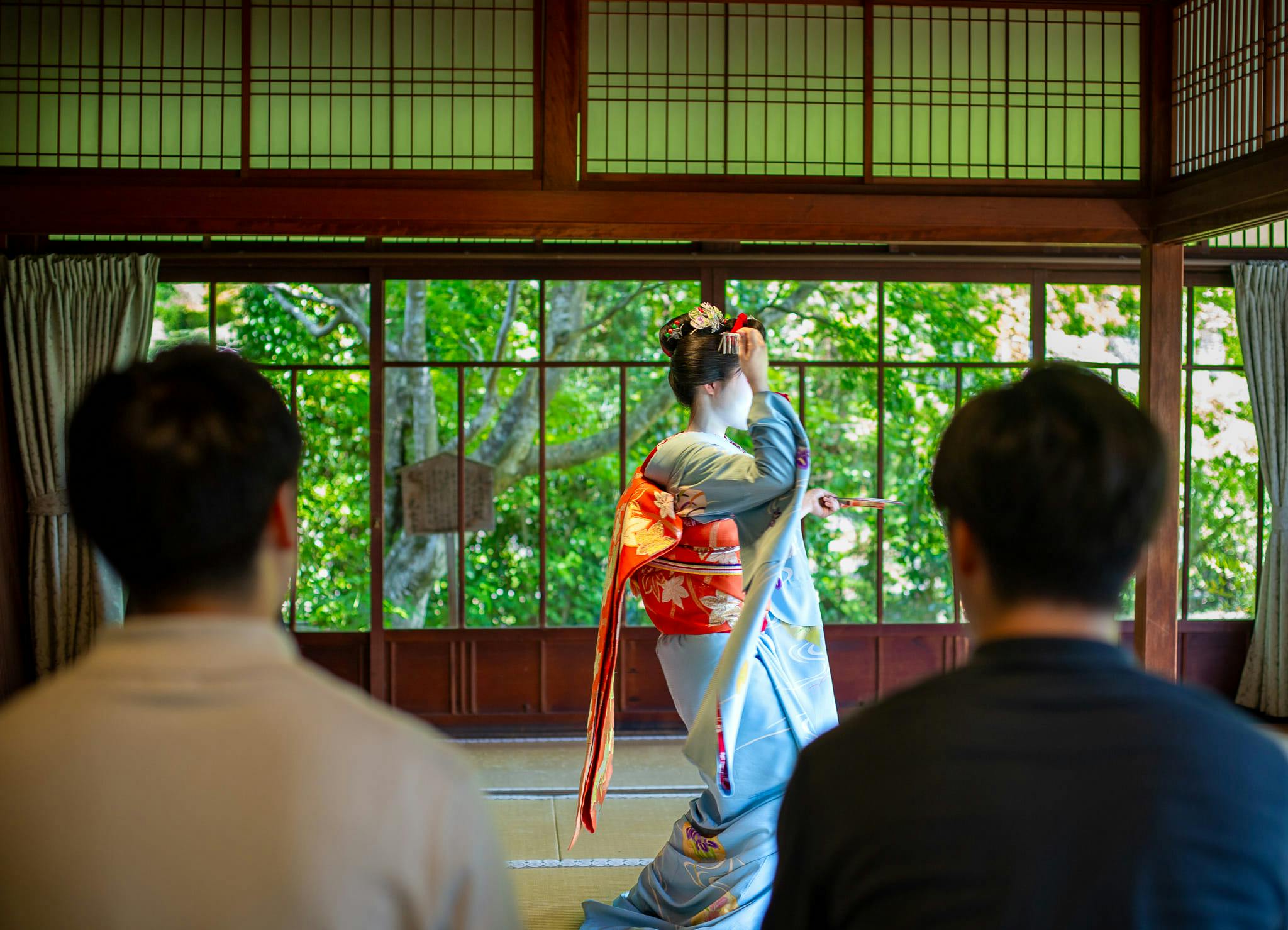 Guests watching a maiko perform a traditional dance in a tatami room at Koun-ji Temple