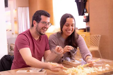 Pair of guests planing chopsticks and laughing