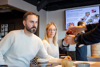 Instructor serving hot water to a private party
