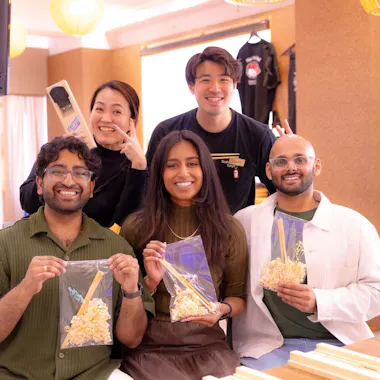 A group photo with your creations. Group posing with staff and their handmade chopsticks