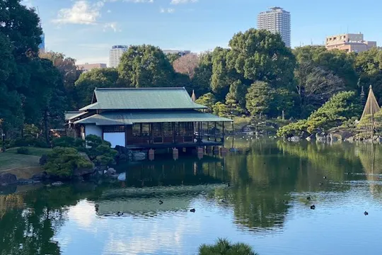 Teahouse reflected in the pond at Kiyosumi Gardens in Tokyo
