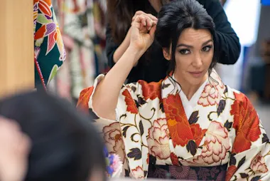 Guest in a red floral kimono having her hair styled