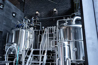 Stainless steel brewing tanks inside a Kamakura craft brewery