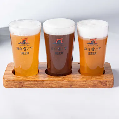 A flight of house-brewed craft beer. Three craft beers in a wooden tasting paddle