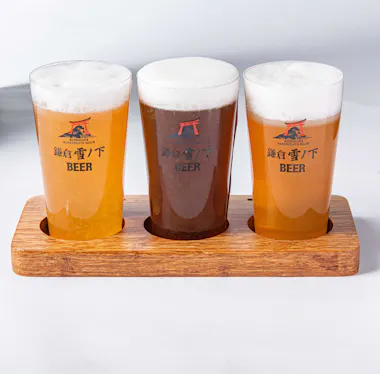 Three craft beers in a wooden tasting paddle