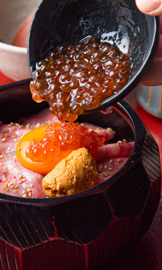 The signature roast beef set meal. Roast beef rice bowl topped with egg yolk, salmon roe, and sea urchin