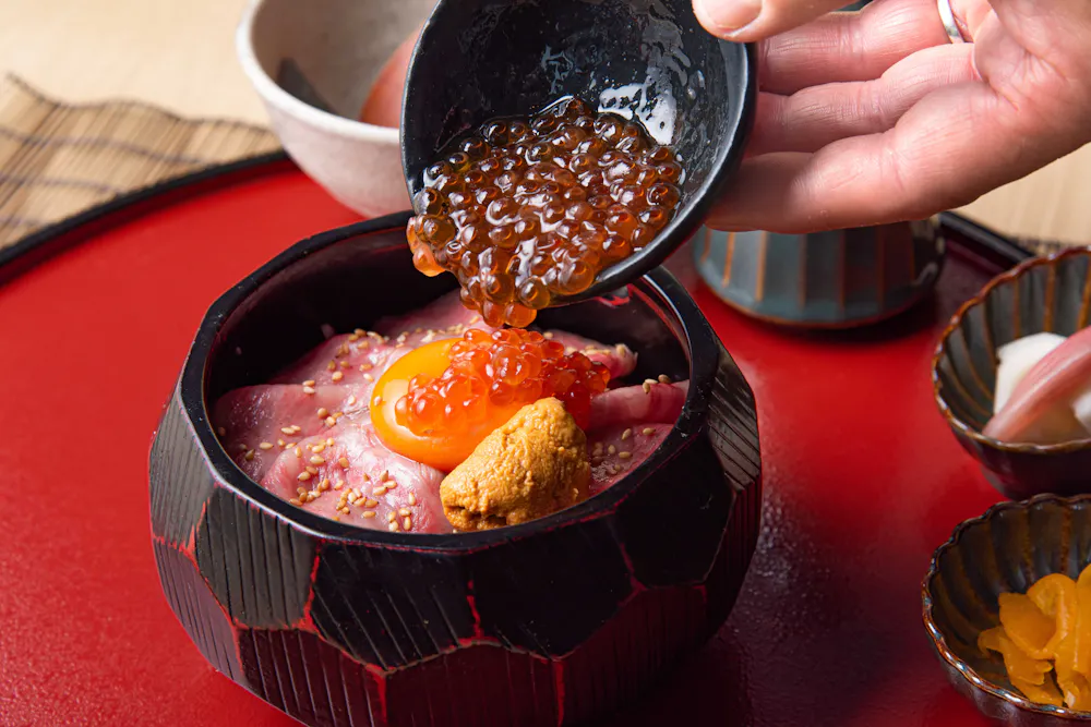 The signature roast beef set meal. Roast beef rice bowl topped with egg yolk, salmon roe, and sea urchin