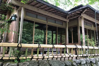 Wooden riverside restaurant surrounded by trees