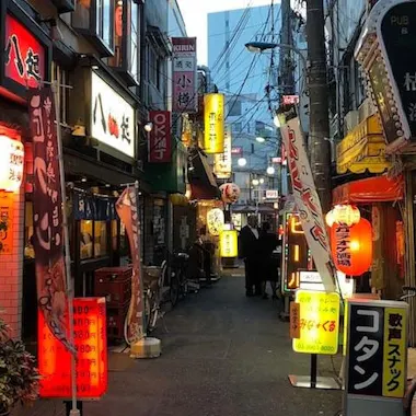 Akabane's retro alleys at dusk. Lantern-lit drinking alley in Akabane at dusk