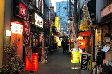 Lantern-lit drinking alley in Akabane at dusk