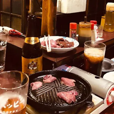 Grilling your own yakiniku. Yakiniku beef grilling on a tabletop burner