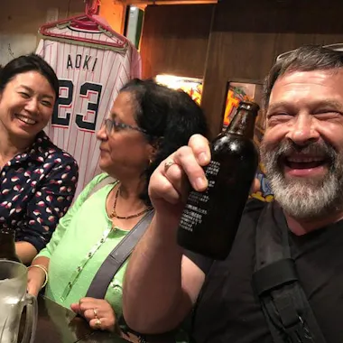 Cheers with the locals. Guide and guests toasting with beer at a Sangenjaya standing bar