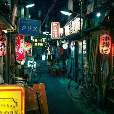 Exploring the back alleys. Narrow alley of bars and glowing signs in Sangenjaya at night