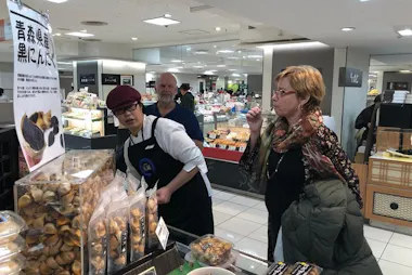 Guest tasting samples at an Ikebukuro department store food hall
