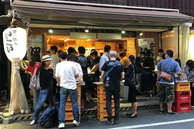 Crowd gathered outside a busy standing bar in Akabane