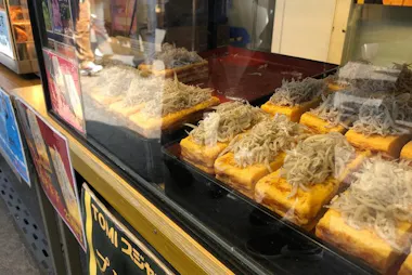 Whitebait-topped snacks on display at a Komachi-dori food stall