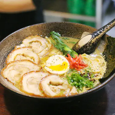 Ramen for a casual meal. Bowl of ramen topped with chashu pork and a soft-boiled egg