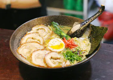 Bowl of ramen topped with chashu pork and a soft-boiled egg