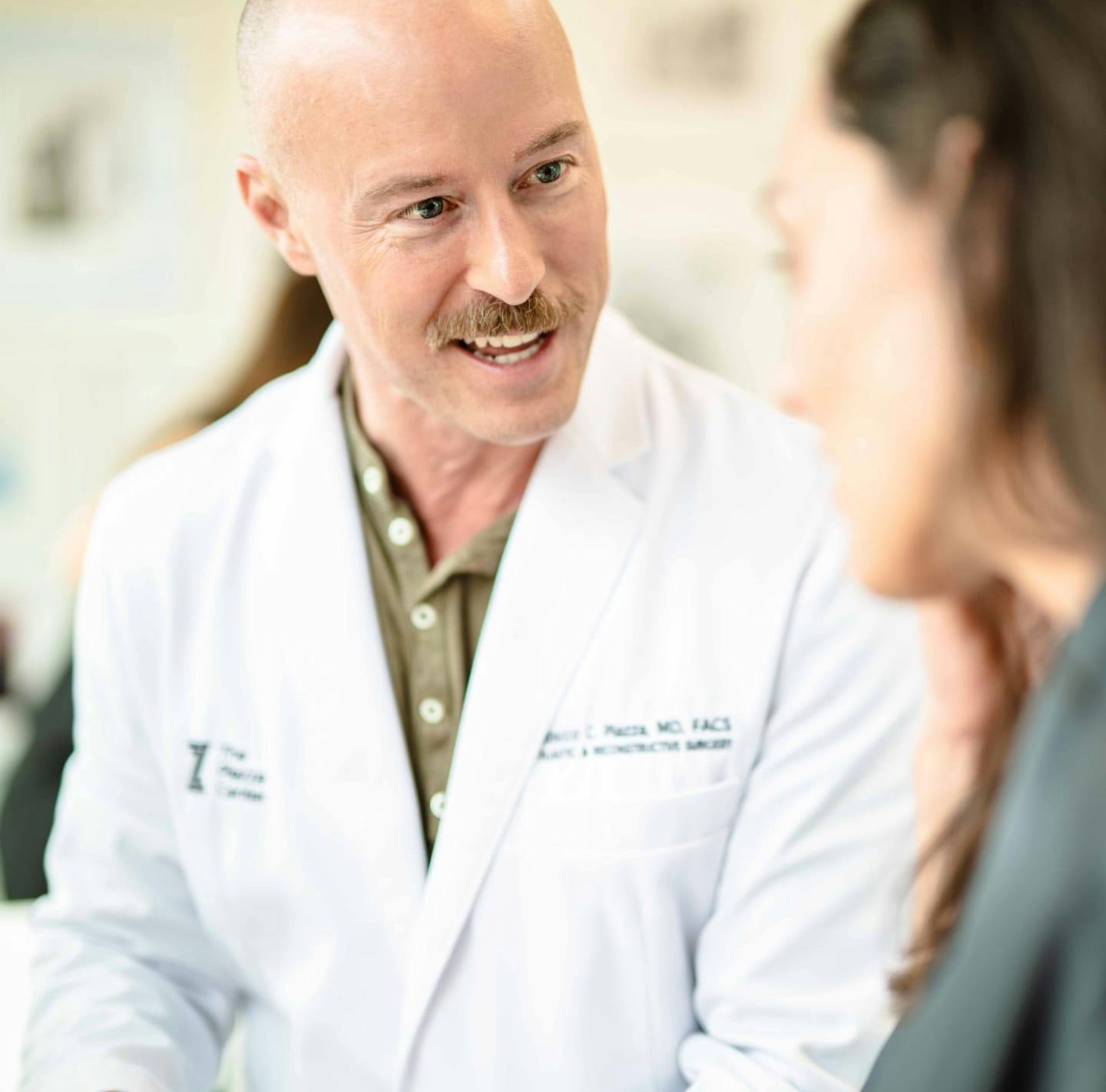 Dr. Piazza speaking with a female patient