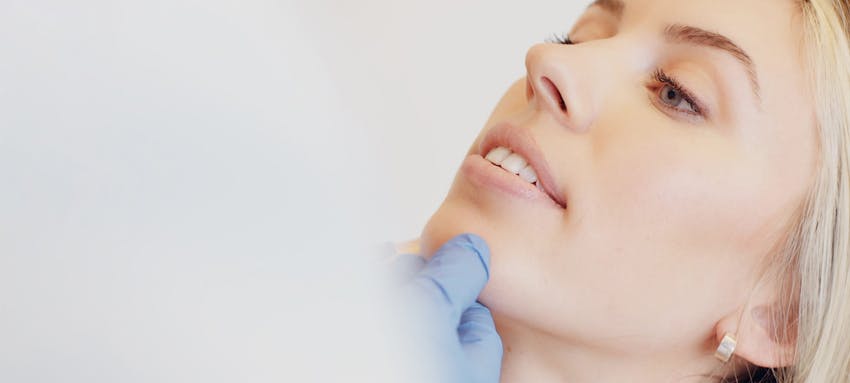 Female patient that is having her face examined by a doctor