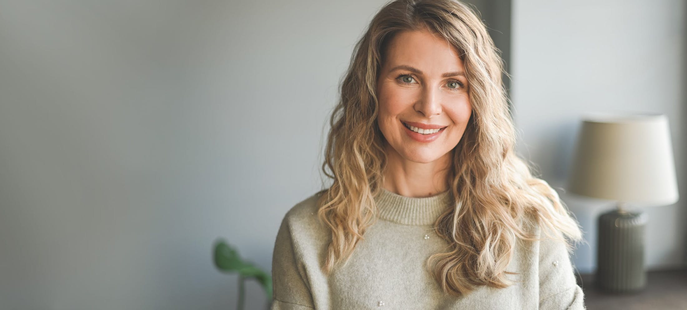 Woman with mid length curly blonde hair