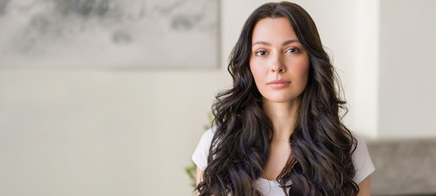 Woman with long dark curly hair