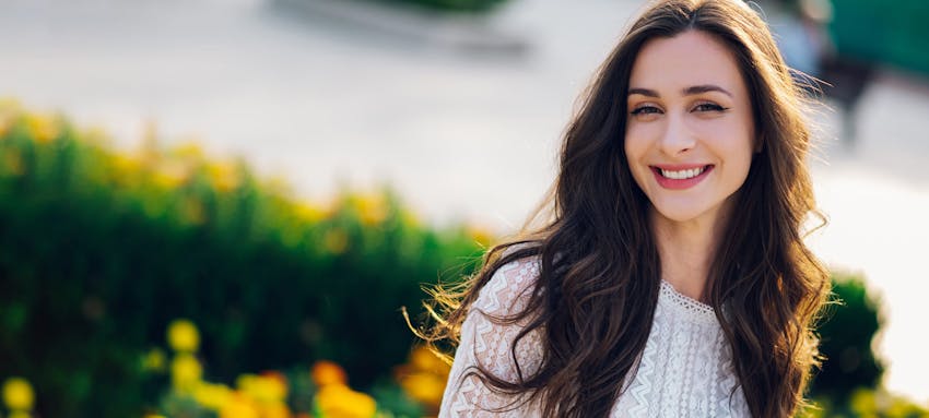 Woman with long brown hair smiling