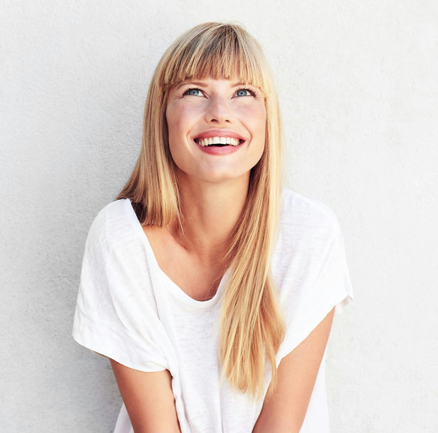 A young blonde woman smiling