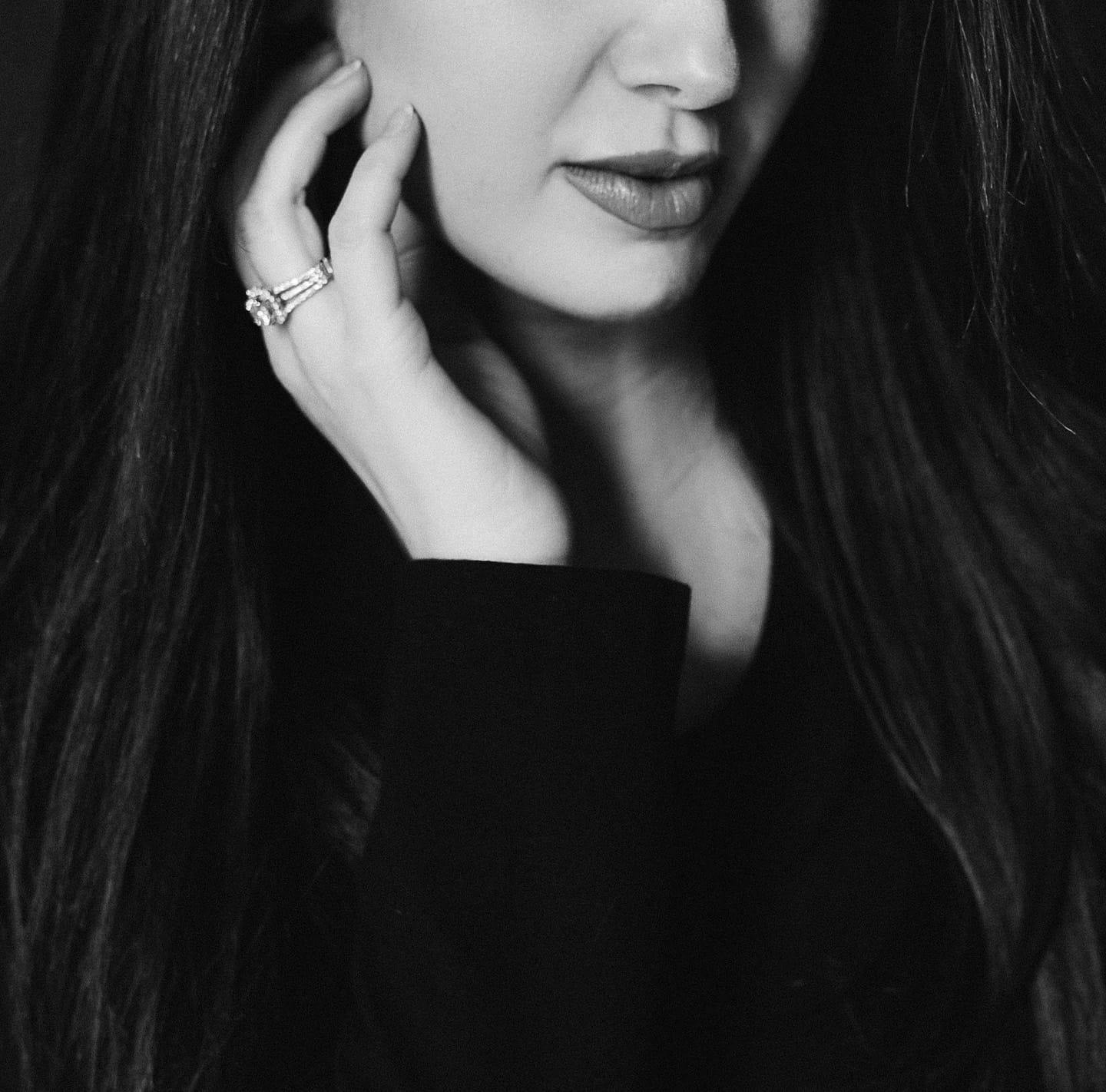 A woman gently touching her face