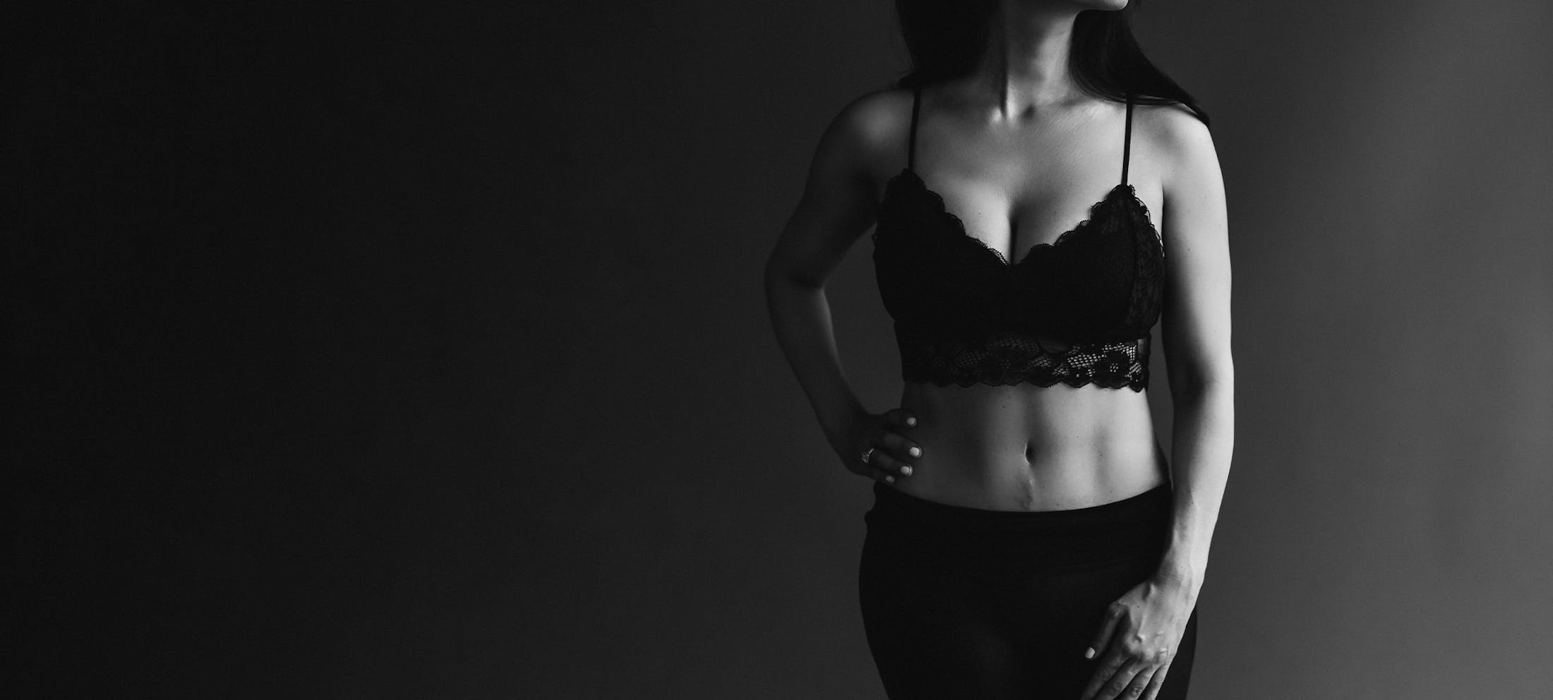 Black and white image of a woman in a black lace bra