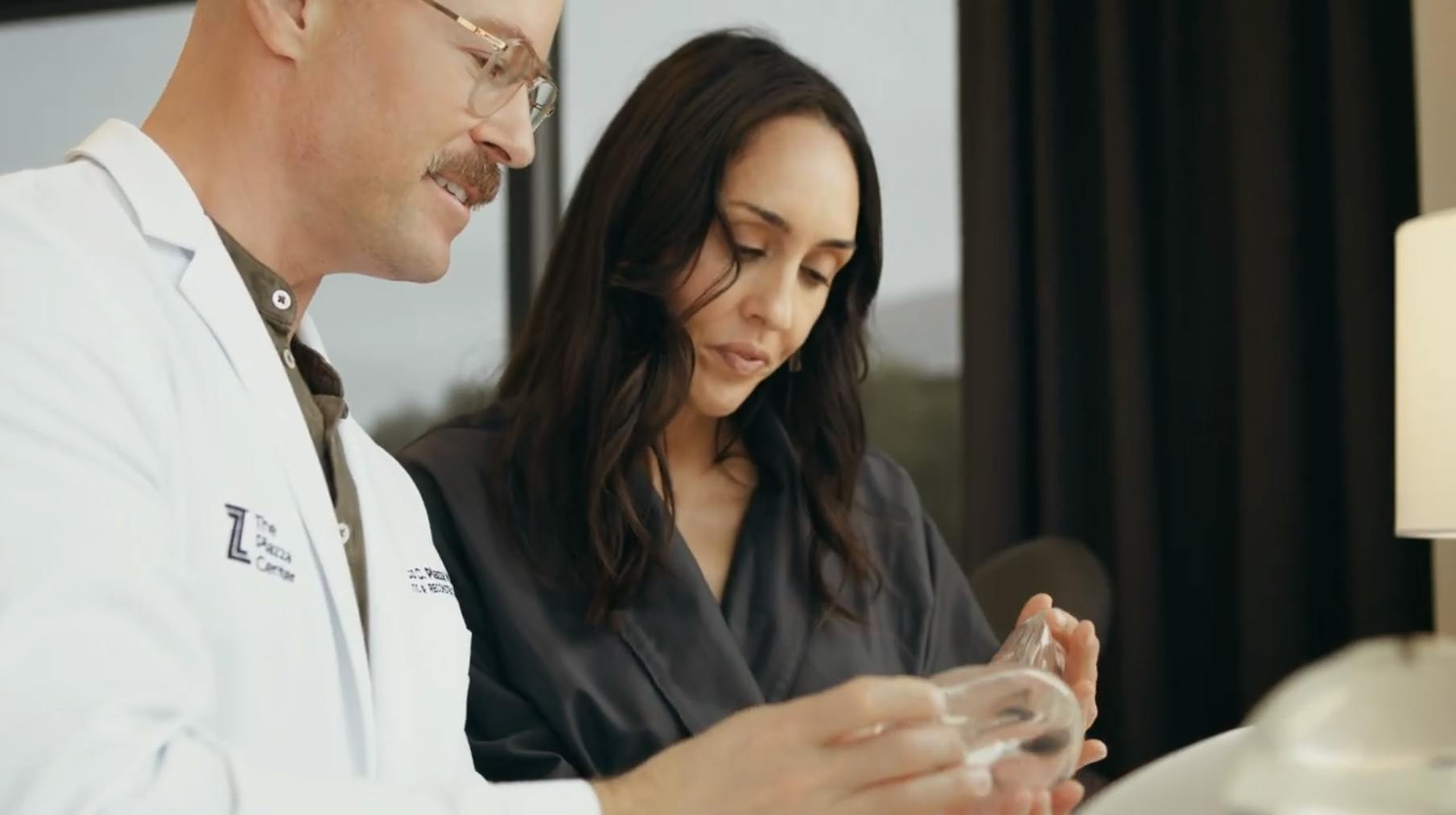 Female patient looking at breast implants with Dr. Piazza