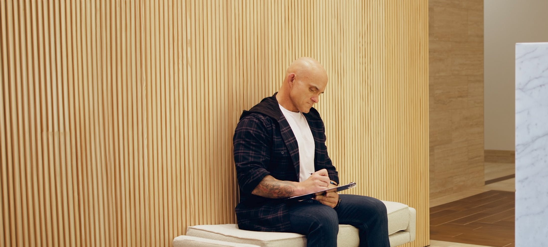 Male patient filling out a patient registration form at The Piazza Center